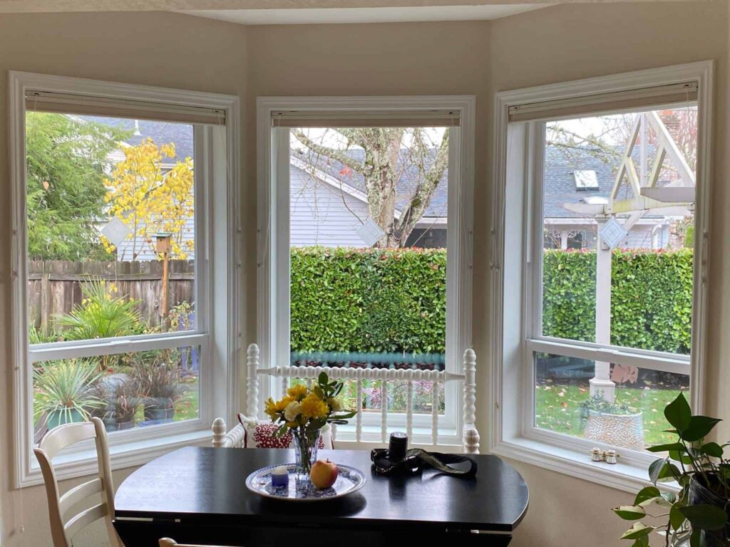 Energy-efficient bay window replacement brightening a cozy dining space in Tualatin, OR.