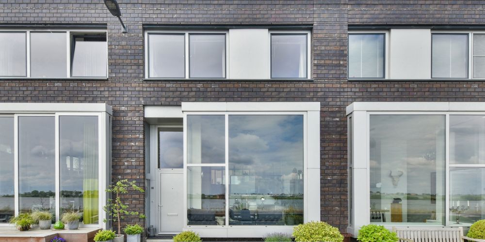 Replacement windows and doors in Portland, OR on a modern brick home exterior