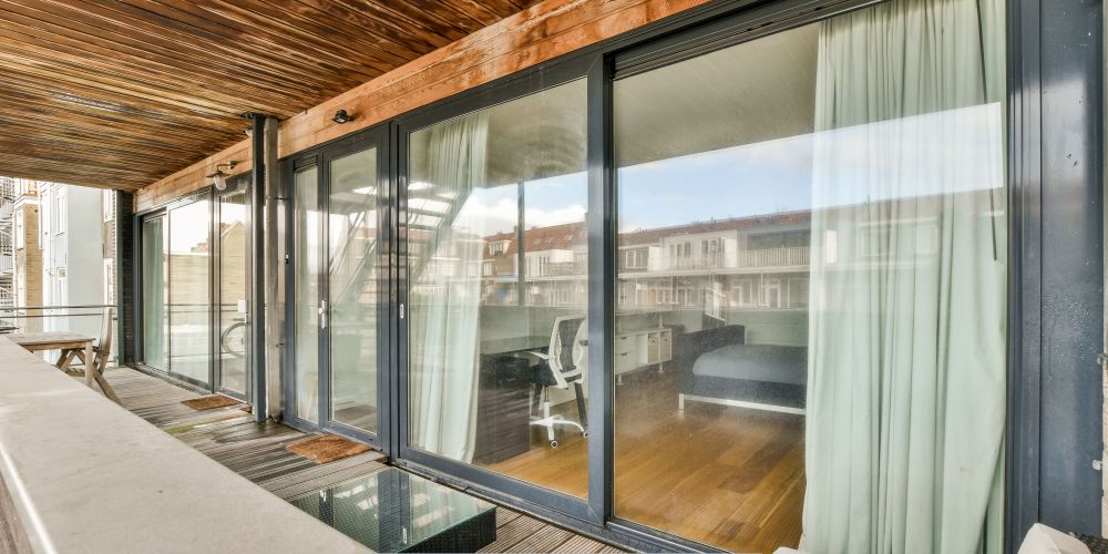 Replacement windows and doors in Tualatin, OR with sliding glass doors opening to a balcony