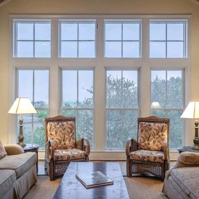 Large replacement windows filling a Tualatin, OR living room with natural light and scenic outdoor views.