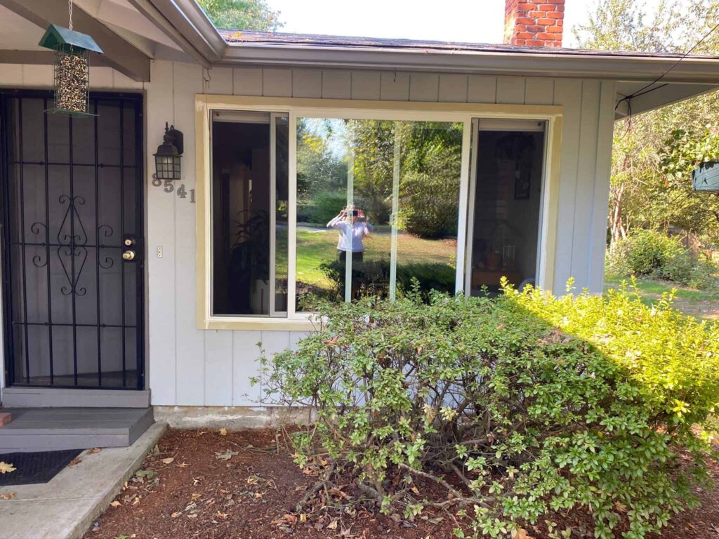 Modern replacement window installed on a home's exterior with landscaped front yard in Tualatin, OR.