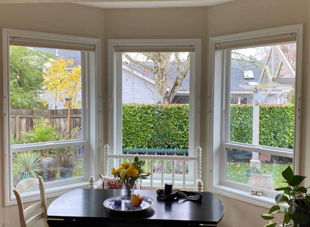 Energy-efficient bay windows brighten a cozy dining space in Beaverton, OR.
